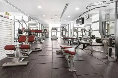 a gym with lots of treadmills and machines at StoneTree - DEC Tower 2 Studio - Dubai Marina in Dubai