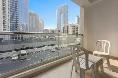a balcony with a chair and a view of a city at StoneTree - DEC Tower 2 Studio - Dubai Marina in Dubai