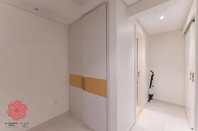 a hallway with white walls and a glass door at Alashrafia Saray- Waterfront 3 BDR apartment Business Bay in Dubai