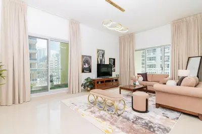 a living room with a couch and a tv at Dubai Marina,JBR -Luxurious 2 BR King Suite in Dubai