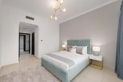 a bedroom with a large bed with a blue headboard at Maison Privee - Dreamy Apt with Jaw-Dropping Marina Views in Dubai