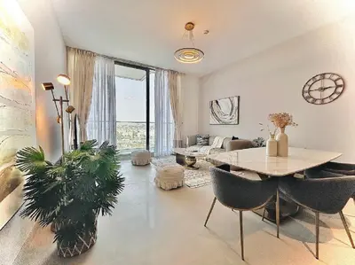 a living room with a table and chairs and a couch at Modern 1 BR Apartment at JVC Dubai Prime Location! in Dubai