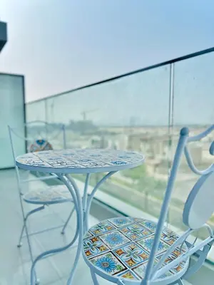 a table and chairs sitting on top of a window at Modern 1 BR Apartment at JVC Dubai Prime Location! in Dubai