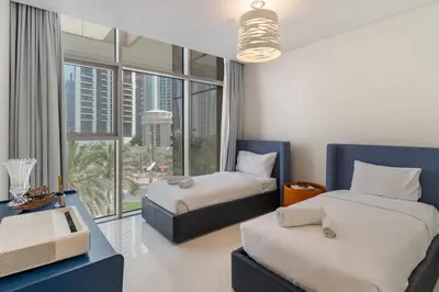 a bedroom with two beds and a large window at Chic 2BR Duplex, Huge Balcony High-End Furniture - Allsopp&Allsopp in Dubai
