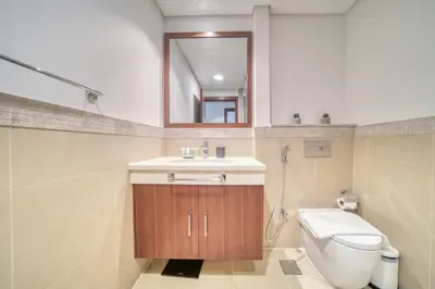 a bathroom with a toilet and a sink and a mirror at Burj Vista Tower 1 - City View, Downtown Dubai - Mint Stay in Dubai