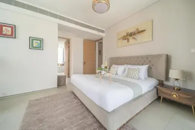 a large white bedroom with a large white bed at Frank Porter - The Address JBR in Dubai