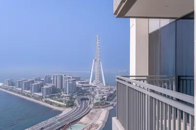 a view of the eiffel tower from the balcony of a building at Sunset spot with breathtaking view by Suiteable in Dubai