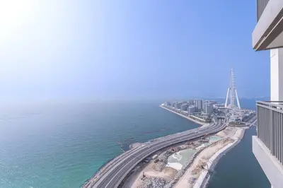 an aerial view of a city and the ocean at Sunset spot with breathtaking view by Suiteable in Dubai