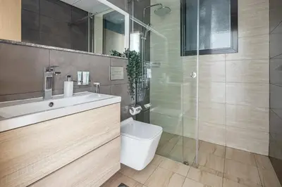 a bathroom with a toilet and a sink and a shower at Frank Porter - Square Tower in Dubai