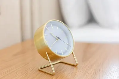 a clock sitting on top of a wooden floor at Charming Brand New 2BR close to the Beach in Dubai