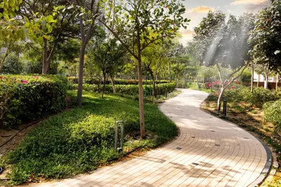 a walkway in a park with trees and flowers at STAY BY LATINEM Luxury 2BR Holiday Home CV A2301 near Burj Khalifa in Dubai