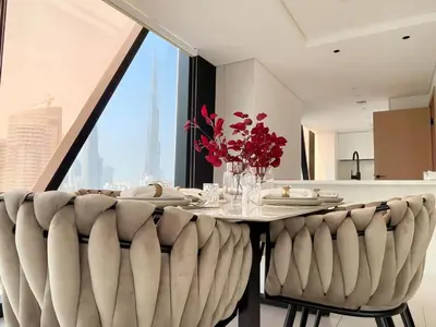 a dining room with a table and a large window at Magnificent 3BR Spectacular Canal & Burj View in Dubai