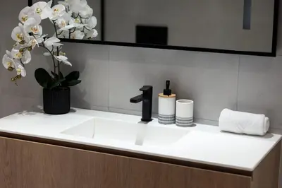 a bathroom sink with a black faucet and a mirror at Magnificent 3BR Spectacular Canal & Burj View in Dubai