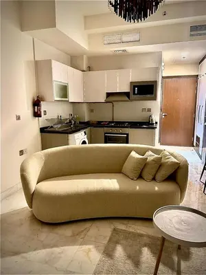 a living room with a couch in a kitchen at Chez Fouzia in Dubai