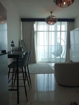 a living room with a table and chairs and a window at Chez Fouzia in Dubai