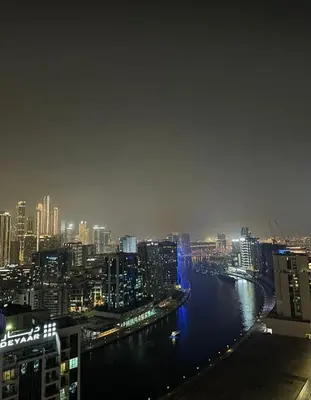 a view of a river in a city at night at Chez Fouzia in Dubai