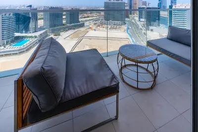 a balcony with a couch and a table and a view at Elegant Studio in City Center with Balcony in Dubai