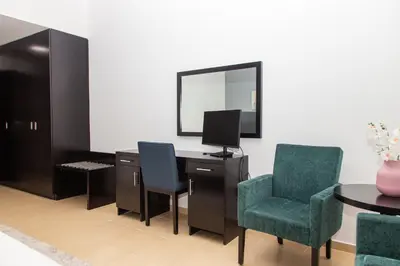 a room with a desk with a computer and two chairs at Shams Apart on JBR - 1 Bedroom - Marina View in Dubai