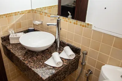 a bathroom with a sink and a white bowl at Shams Apart on JBR - 1 Bedroom - Marina View in Dubai