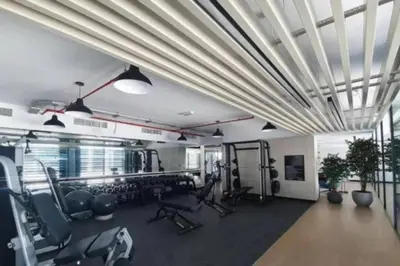 a gym with treadmills and chairs in a room at 1bdr in Belgravia Heights - JVC - Dubai in Dubai