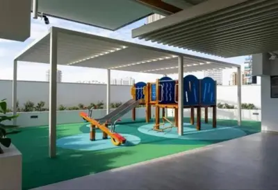 a playground with blue chairs and a slide at 1bdr in Belgravia Heights - JVC - Dubai in Dubai