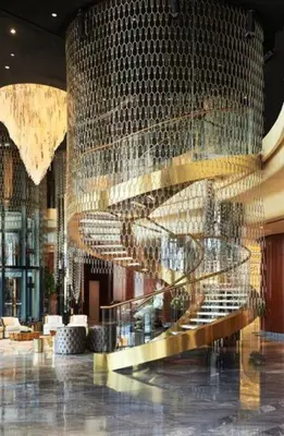 a lobby with a staircase and a large wall of mirrors at Keysplease Luxury 1 B/R Apt in Paramount Towers by Damac in Dubai