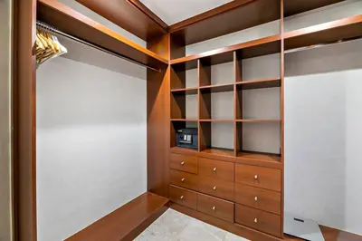 a closet with wooden shelves and a microwave in it at StoneTree - Fairmont North 2 BR - Beach Access in Dubai