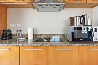 a kitchen counter with a microwave and a sink at StoneTree - Attessa Tower 1BR - Amazing View in Dubai