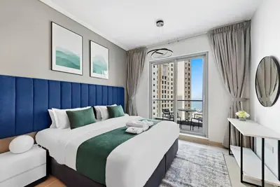 a bedroom with a large bed and a large window at StoneTree - Attessa Tower 1BR - Amazing View in Dubai
