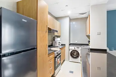 a kitchen with a stainless steel refrigerator and a dishwasher at StoneTree - Marina Crown 1 BR - Dubai Marina in Dubai
