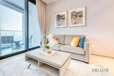 a living room with a couch and a table at Stylish 1BR in Prime Location, Book Your Stay by Deluxe Holiday Homes in Dubai