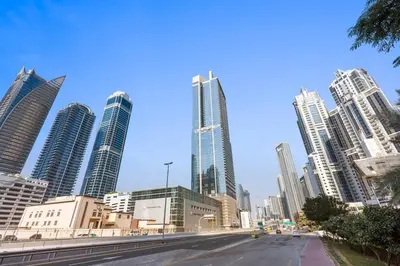 a street in a city with tall buildings at StoneTree - Paramount 3 BR - Infinity Pool in Dubai