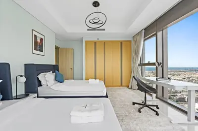 a hotel room with a bed and a desk at StoneTree - Paramount 3 BR - Infinity Pool in Dubai