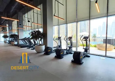 a gym with a row of treadmills in a building at Fully Furnished 1 Bed in Downtown Dubai, Hosted by Desert City Stays in Dubai