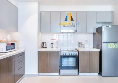 a kitchen with a refrigerator freezer and a stove at Fully Furnished 1 Bed in Downtown Dubai, Hosted by Desert City Stays in Dubai