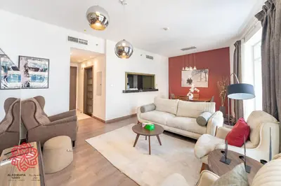 a living room with a couch and a table at Alashrafia Saray- Central 2BR apartment in Downtown in Dubai