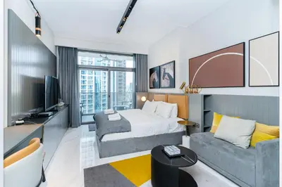 a hotel room with a bed and a couch at MAG 318 Studio Walk to Dubai Mall in Dubai