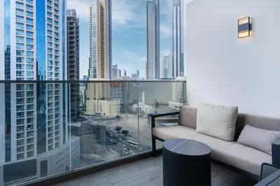 a living room with a couch and a view of a city at MAG 318 Studio Walk to Dubai Mall in Dubai