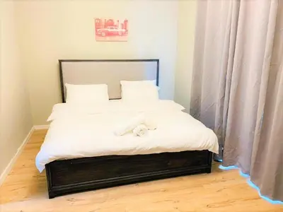 a bed with white sheets and two towels on it at Royal Manor- Marina Diamond 2 in Dubai