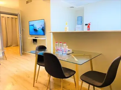a dining room with a glass table and chairs at Royal Manor- Marina Diamond 2 in Dubai