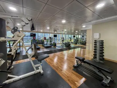 a gym with treadmills and exercise bikes in it at StoneTree - Indigo Tower 1BR - Panoramic View in Dubai