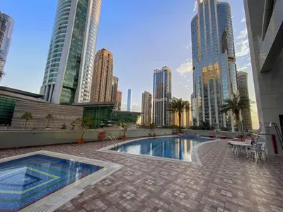 a pool in the middle of a city with tall buildings at StoneTree - Indigo Tower 1BR - Panoramic View in Dubai