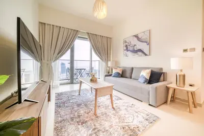 a living room with a couch and a tv at Burj Royale, Downtown Dubai - Mint Stay in Dubai