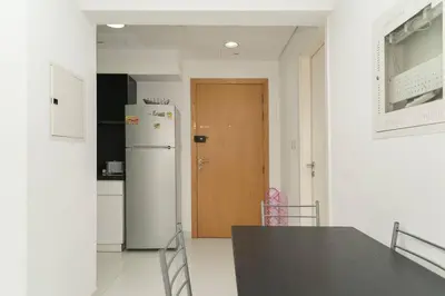 a kitchen with a table and a wooden door at StoneTree - Elegant Studio in Business Bay in Dubai