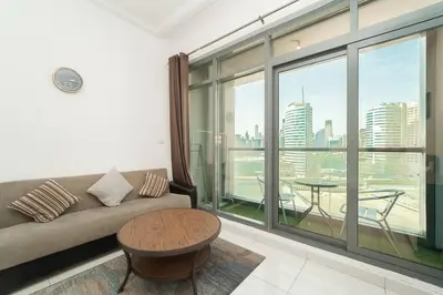 a living room with a couch and a table at StoneTree - Elegant Studio in Business Bay in Dubai
