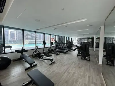 a gym with a bunch of exercise equipment in a building at Trophy Amazing Burj Khalifa Views from This Stylish Condo in Dubai