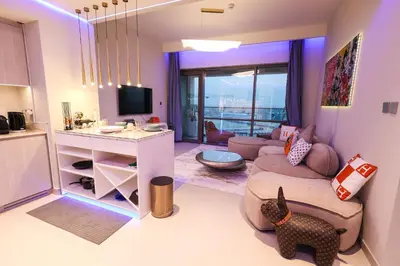 a living room with a couch and a table at VIDA Premier Deluxe - Creek Beach - Beachfront Bliss in Dubai