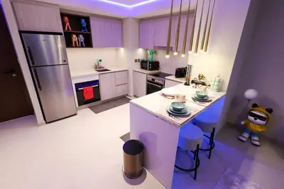 a kitchen with a refrigerator and a table and chairs at VIDA Premier Deluxe - Creek Beach - Beachfront Bliss in Dubai