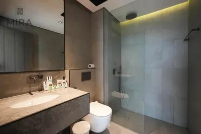 a bathroom with a sink and a toilet and a shower at Mira Holiday Homes - Newly 1 bedroom with pool access in Dubai