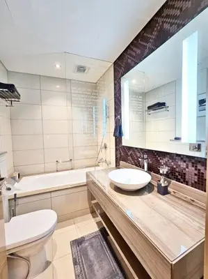 a bathroom with a sink and a toilet and a tub at Luxury Paramount Hotel Apt D111 in Dubai
